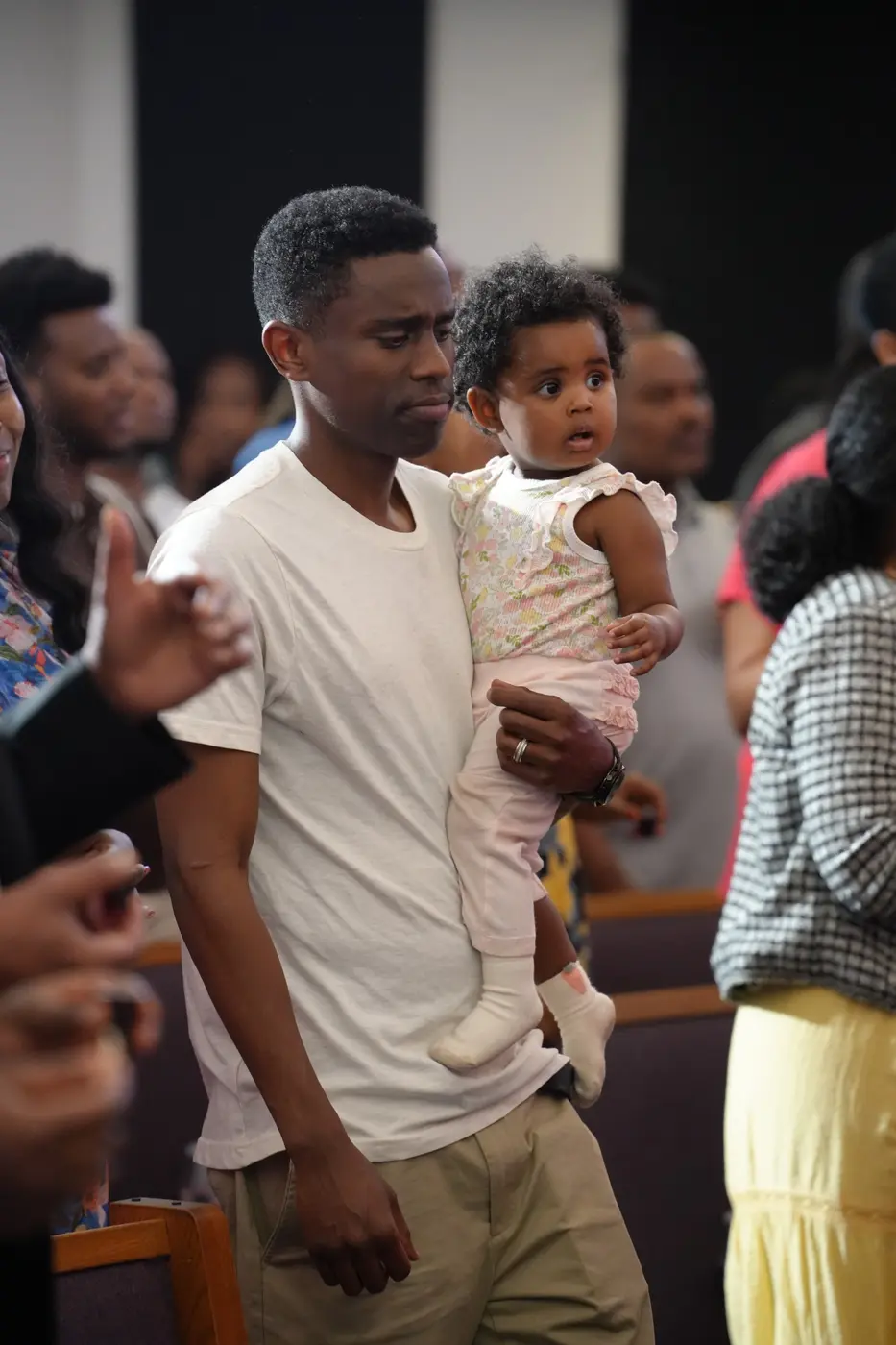 A parent and child participating in church