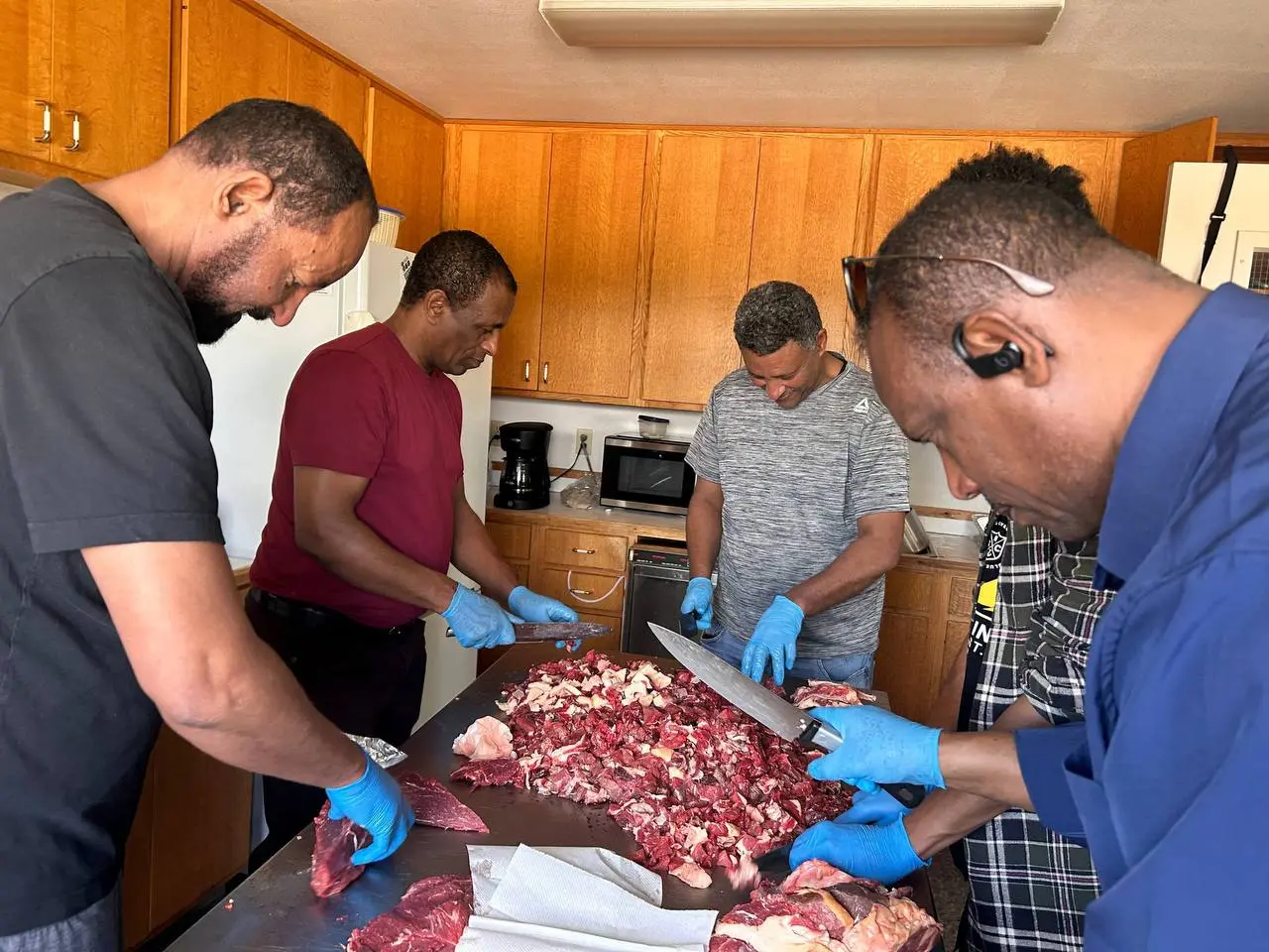 Men preparing food together during Brothers’ Fellowship