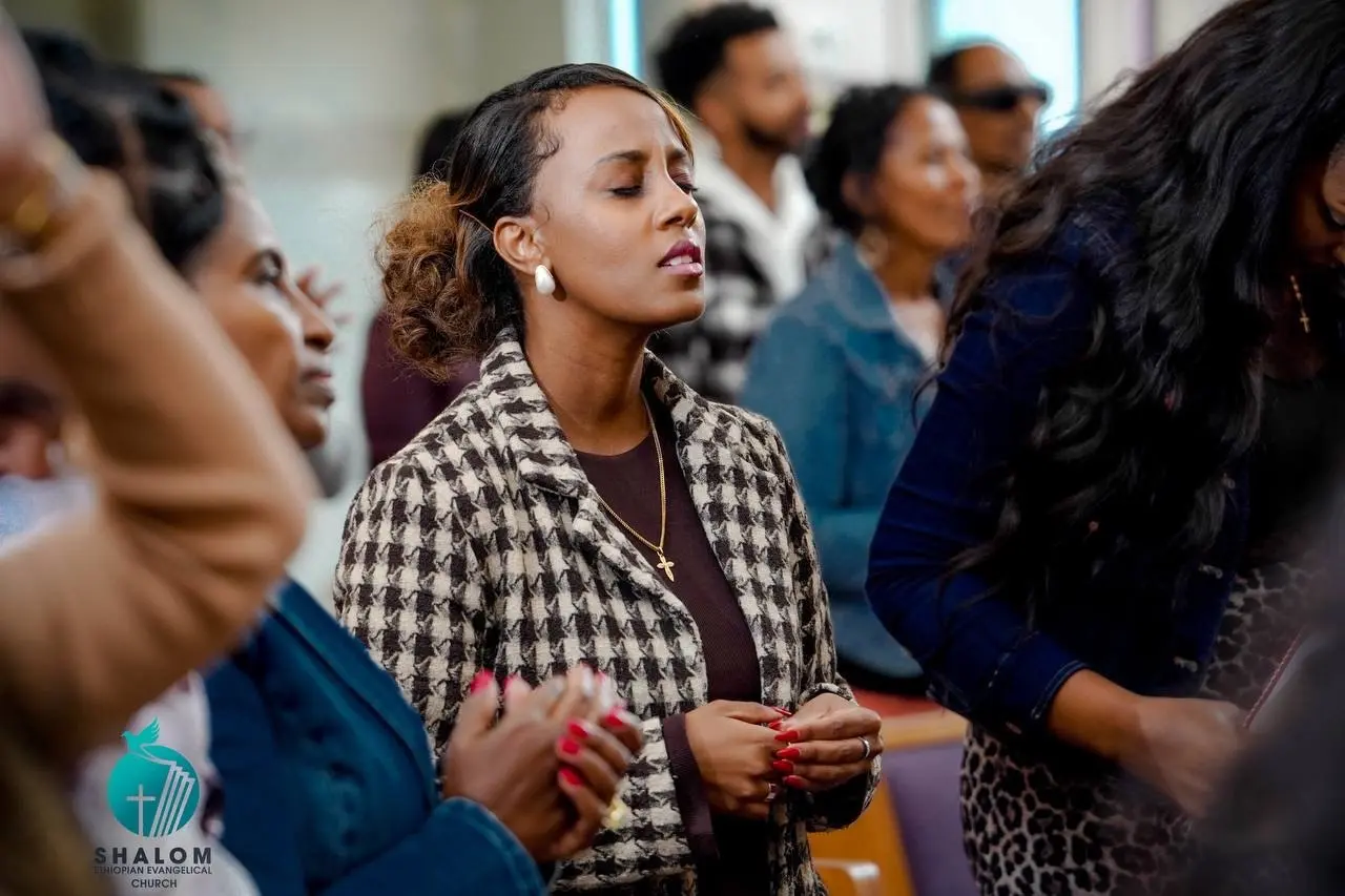 A young adult worshiping with the church community